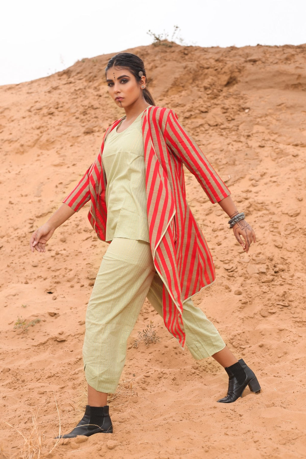 Top With Pants And Red Striped Cape - Set Of Three at Kamakhyaa by Keva. This item is Cape, Co-ord Sets, Cotton, Cotton Lurex, Desert Rose, Natural, Office Wear Co-ords, Red, Relaxed Fit, Resort Wear, Stripes, Travel, Travel Co-ords, Womenswear