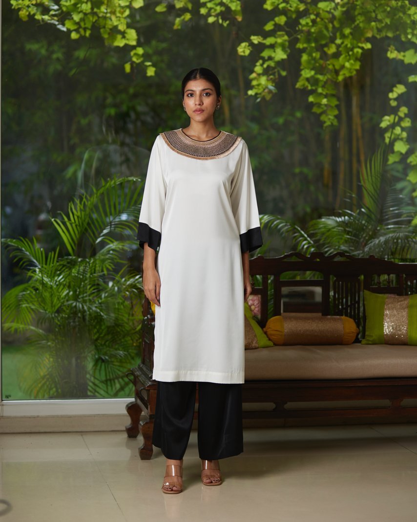 White And Black Satin Silk Kurta Pant Set at Kamakhyaa by Mayura Kumar. This item is Black, Casual Wear, Festive Wear, Kurta Pant Sets, Mayura Kumar, Regular Fit, Satin, Silk, Solids, Timeless Elegance, White, Womenswear