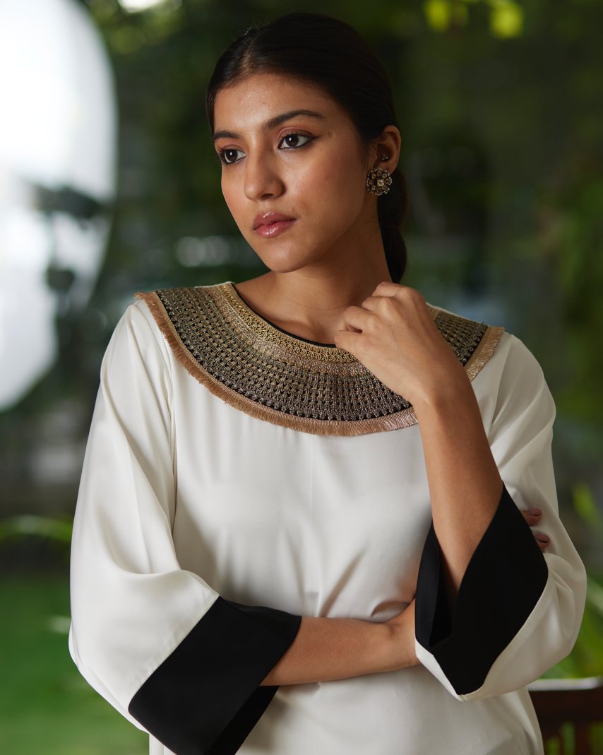 White And Black Satin Silk Kurta Pant Set at Kamakhyaa by Mayura Kumar. This item is Black, Casual Wear, Festive Wear, Kurta Pant Sets, Mayura Kumar, Regular Fit, Satin, Silk, Solids, Timeless Elegance, White, Womenswear