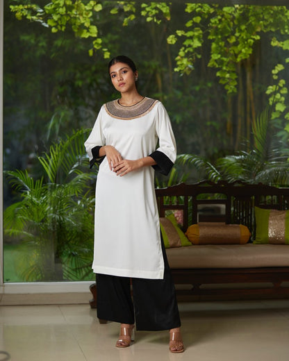 White And Black Satin Silk Kurta Pant Set at Kamakhyaa by Mayura Kumar. This item is Black, Casual Wear, Festive Wear, Kurta Pant Sets, Mayura Kumar, Regular Fit, Satin, Silk, Solids, Timeless Elegance, White, Womenswear