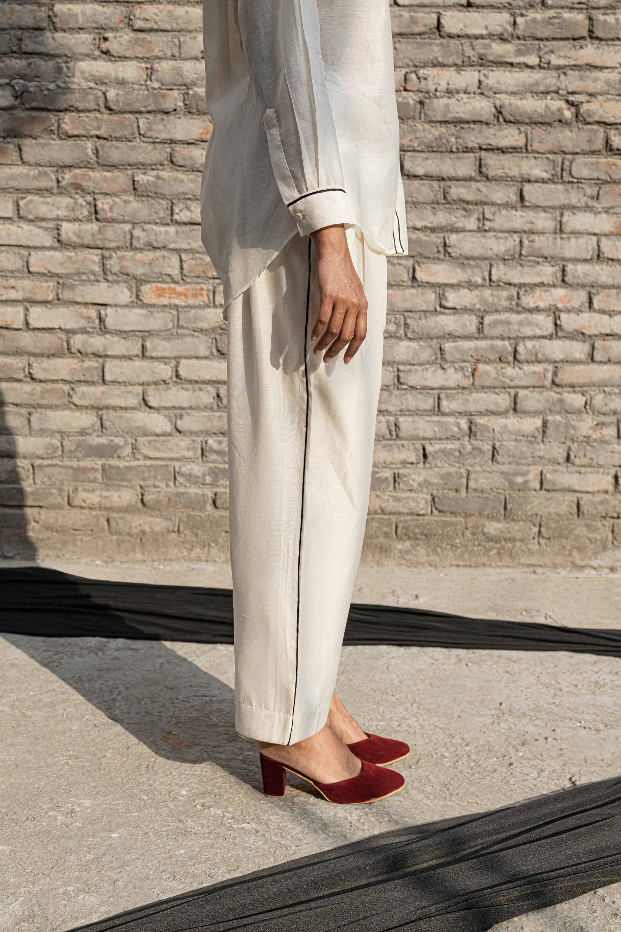White Classic Pants at Kamakhyaa by Ahmev. This item is Casual Wear, Chanderi, Ink And Ivory, Natural, Pants, Prints, Relaxed Fit, White, Womenswear