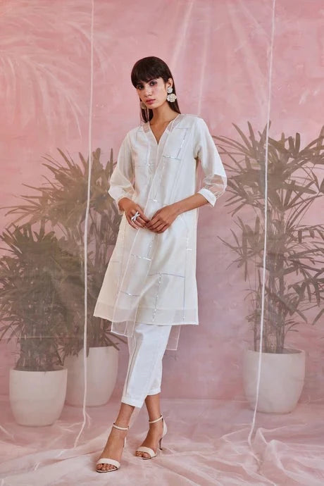 White Cotton Kurta Set With Organza Dupatta at Kamakhyaa by Charkhee. This item is Aasmaa, Chanderi, Cotton, Embellished, Indian Wear, Kurta Pant Sets, Kurta Set With Dupatta, Natural, Organza, Relaxed Fit, Sequin work, Wedding Wear, White, Womenswear