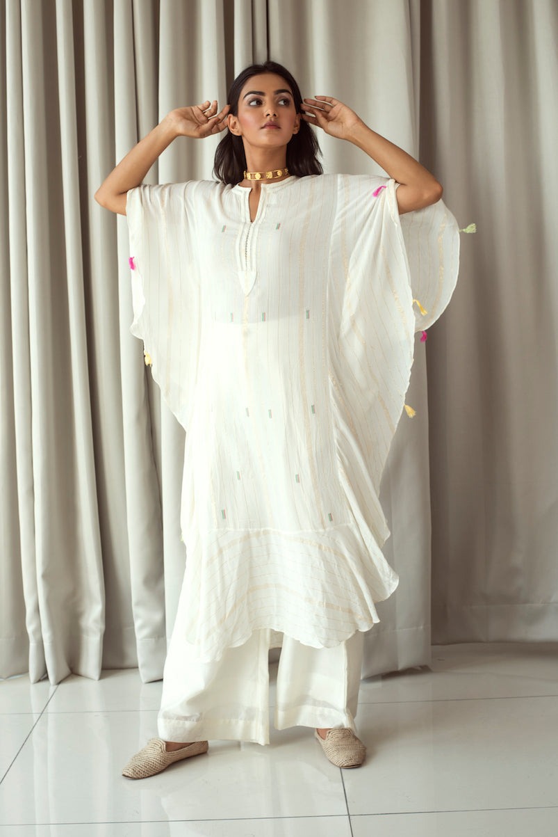 White Embroidered Kaftan at Kamakhyaa by Taro. This item is Bahaar Taro, Cotton Blend, Evening Wear, Indian Wear, July Sale, July Sale 2023, Kaftans, Natural, Regular Fit, Textured, Tops, White, Womenswear
