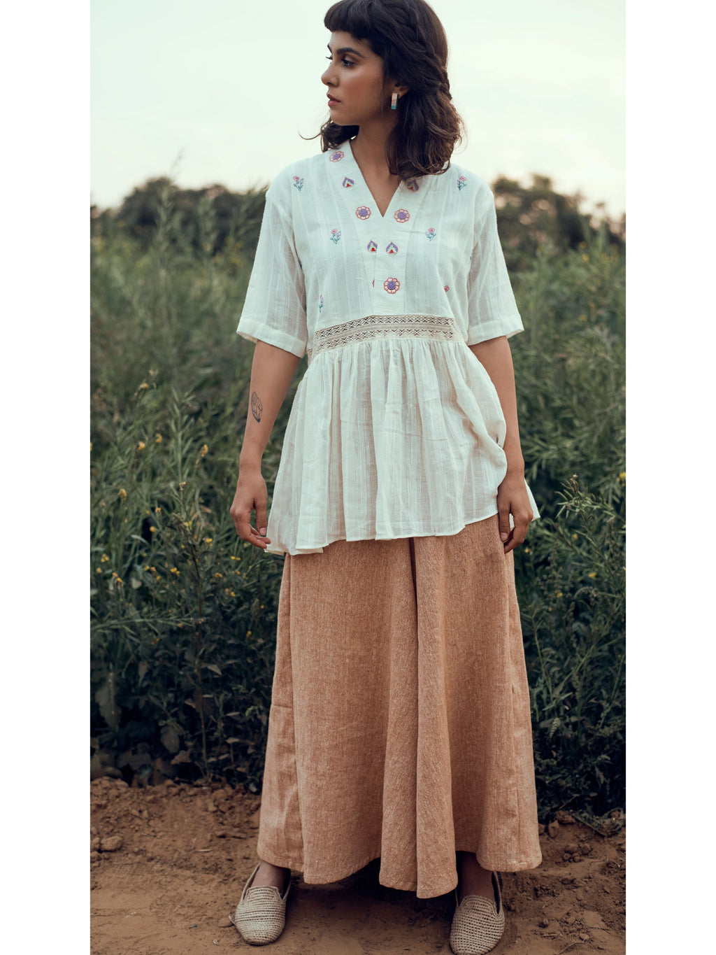 White Floral Embroidered Tunic Top at Kamakhyaa by The Loom Art. This item is Embroidered, July Sale, July Sale 2023, Natural, Organic, Party Wear, Peplum Tops, Permanent Vacation, Regular Fit, Tops, White, Womenswear