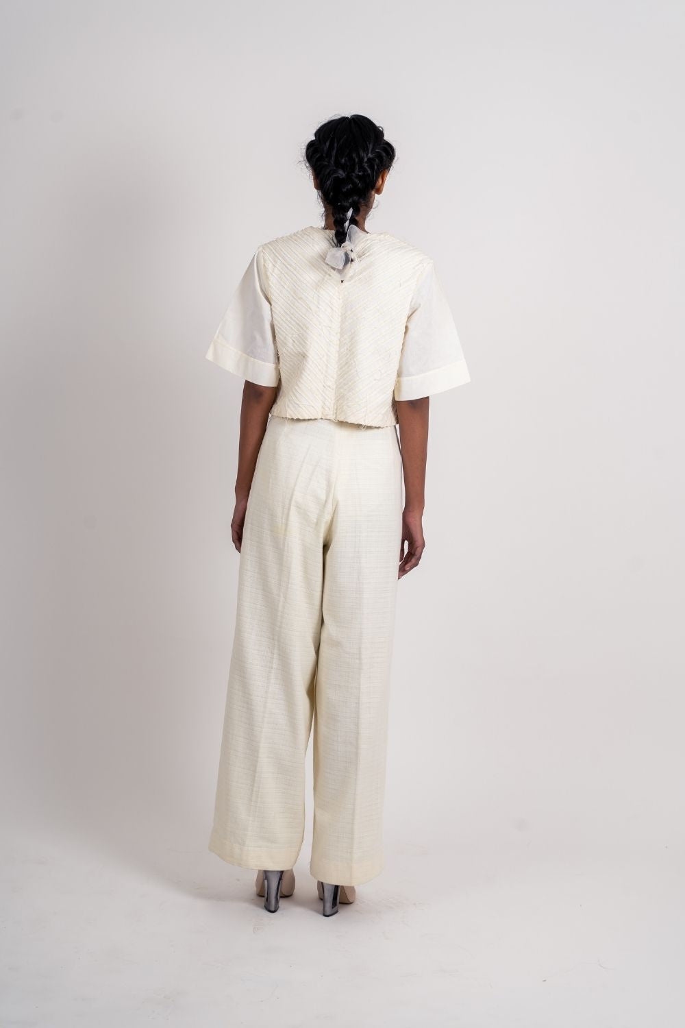 White Pleated Pants at Kamakhyaa by Ahmev. This item is Bottoms, Casual Wear, Fitted At Waist, Handloom Cotton, July Sale, July Sale 2023, Natural, Palazzo Pants, Textured, White, Womenswear