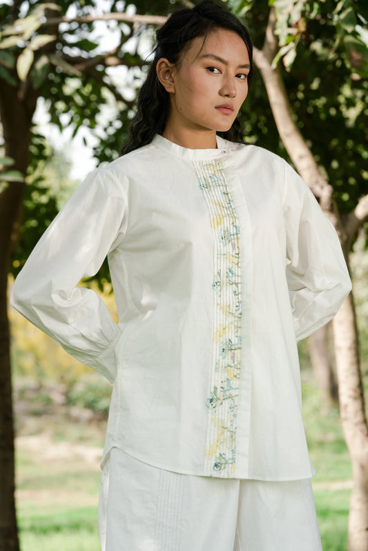 White Pleated placket shirt at Kamakhyaa by Ahmev. This item is Batik, Casual Wear, Cotton, Handpainted, July Sale, July Sale 2023, Natural, Prints, Regular Fit, Shirts, Tops, White, Womenswear