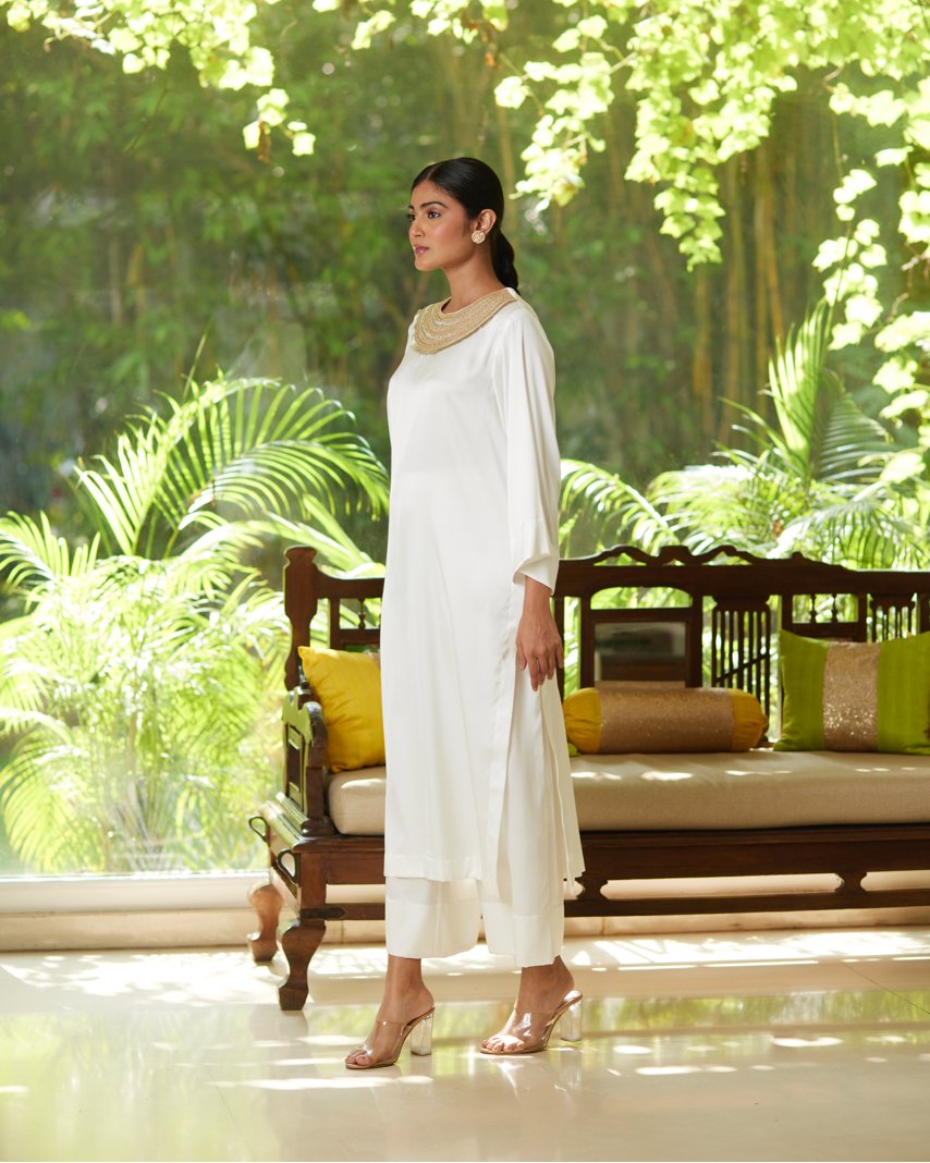 White Satin Silk Kurta Pant Set at Kamakhyaa by Mayura Kumar. This item is Casual Wear, Festive Wear, Kurta Pant Sets, Mayura Kumar, Regular Fit, Satin, Silk, Solids, Timeless Elegance, White, Womenswear