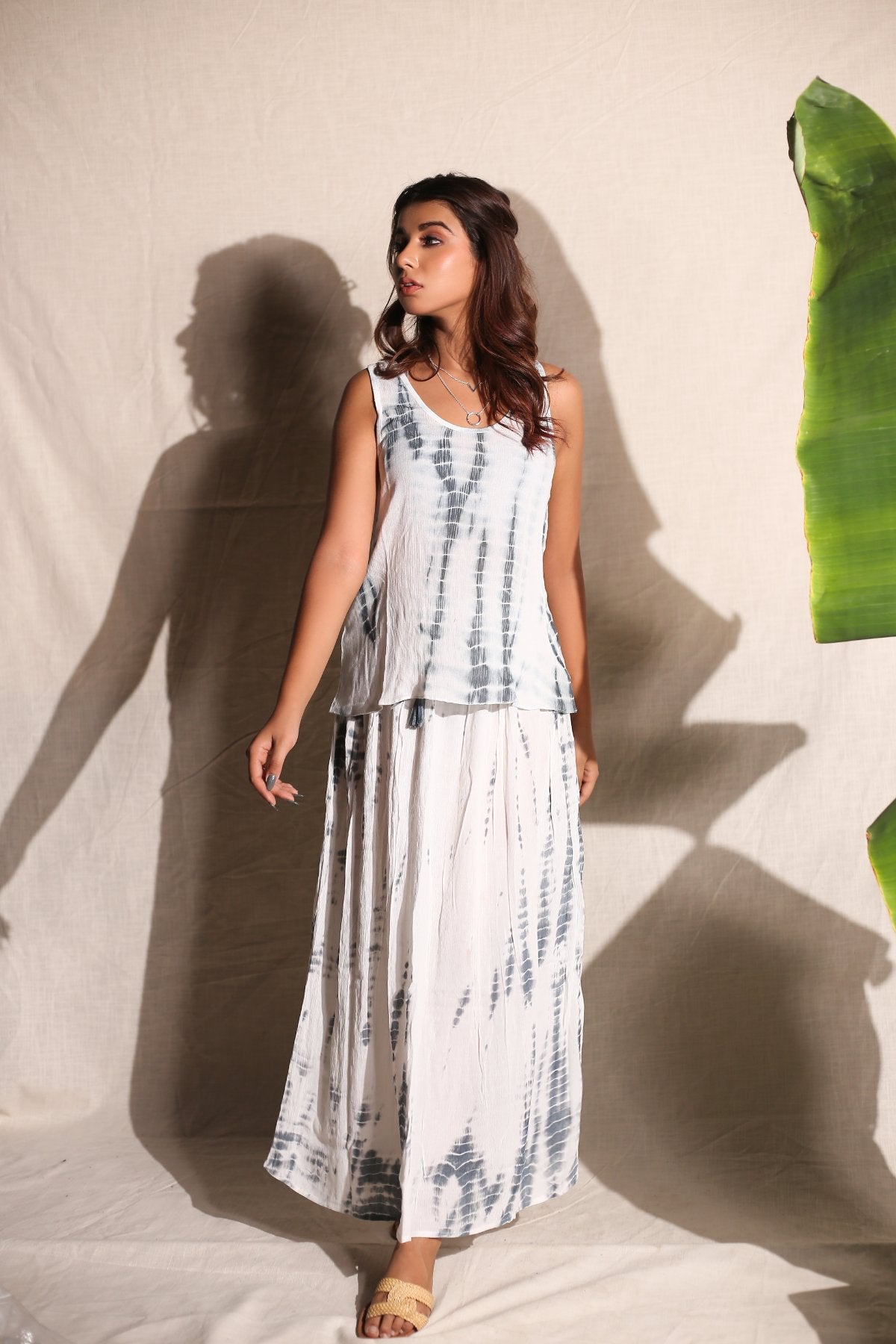 White Skirt And Top- Set of Two at Kamakhyaa by Keva. This item is Best Selling, Co-ord Sets, Crepe, Day Dream, Lounge Wear Co-ords, Natural, Rayon, Relaxed Fit, Resort Wear, Skirt Sets, Tie & Dye, Vacation Co-ords, White, Womenswear