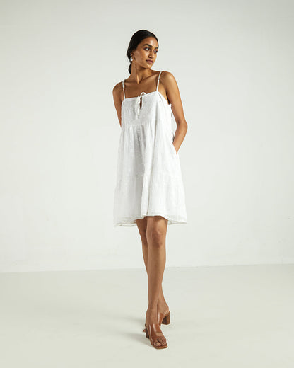 White Sleeveless Tier Dress at Kamakhyaa by Reistor. This item is Bemberg, Best Selling, Casual Wear, Chiffon, FB ADS JUNE, Highend fashion, Mini Dresses, Natural, Sleeveless Dresses, Solids, White, Womenswear