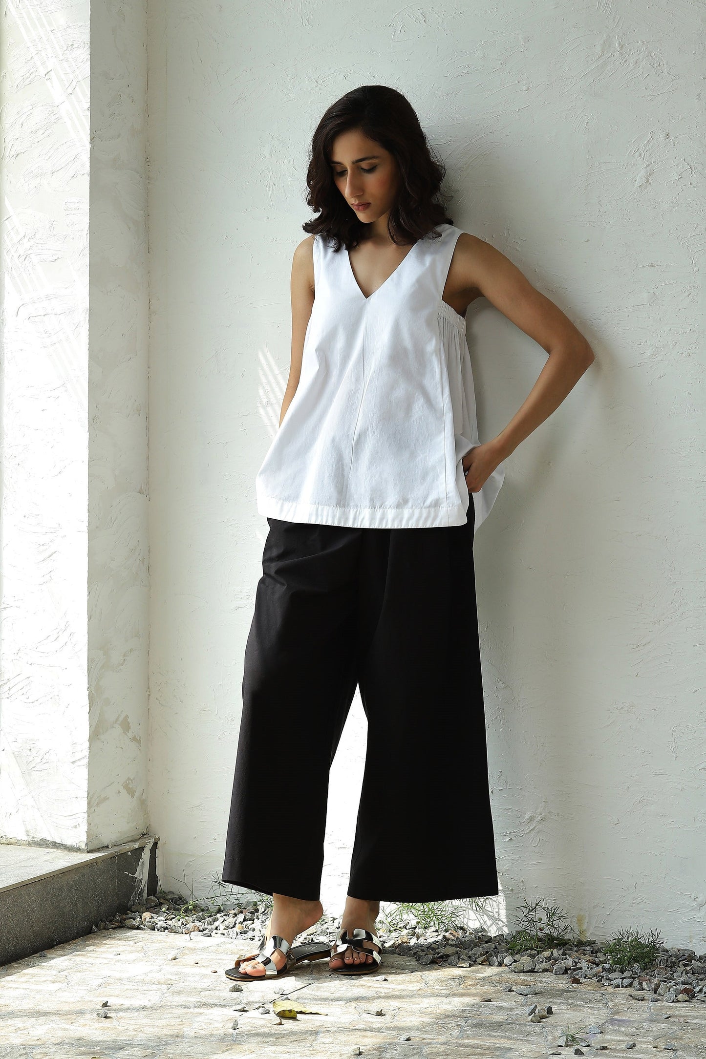 White Sleeveless V Neck Top With Black Flared Pant Set at Kamakhyaa by Canoopi. This item is Black, Canoopi, Casual Wear, Complete Sets, Natural, Poplin, Regular Fit, Solids, Vacation Co-ords, White, Womenswear