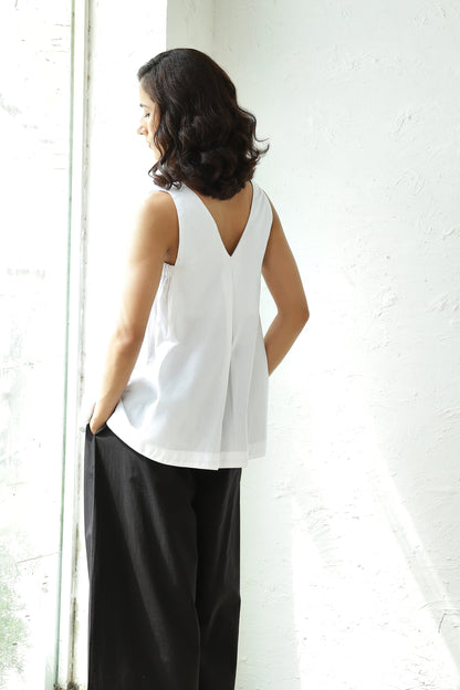 White Sleeveless V Neck Top With Black Flared Pant Set at Kamakhyaa by Canoopi. This item is Black, Canoopi, Casual Wear, Complete Sets, Natural, Poplin, Regular Fit, Solids, Vacation Co-ords, White, Womenswear