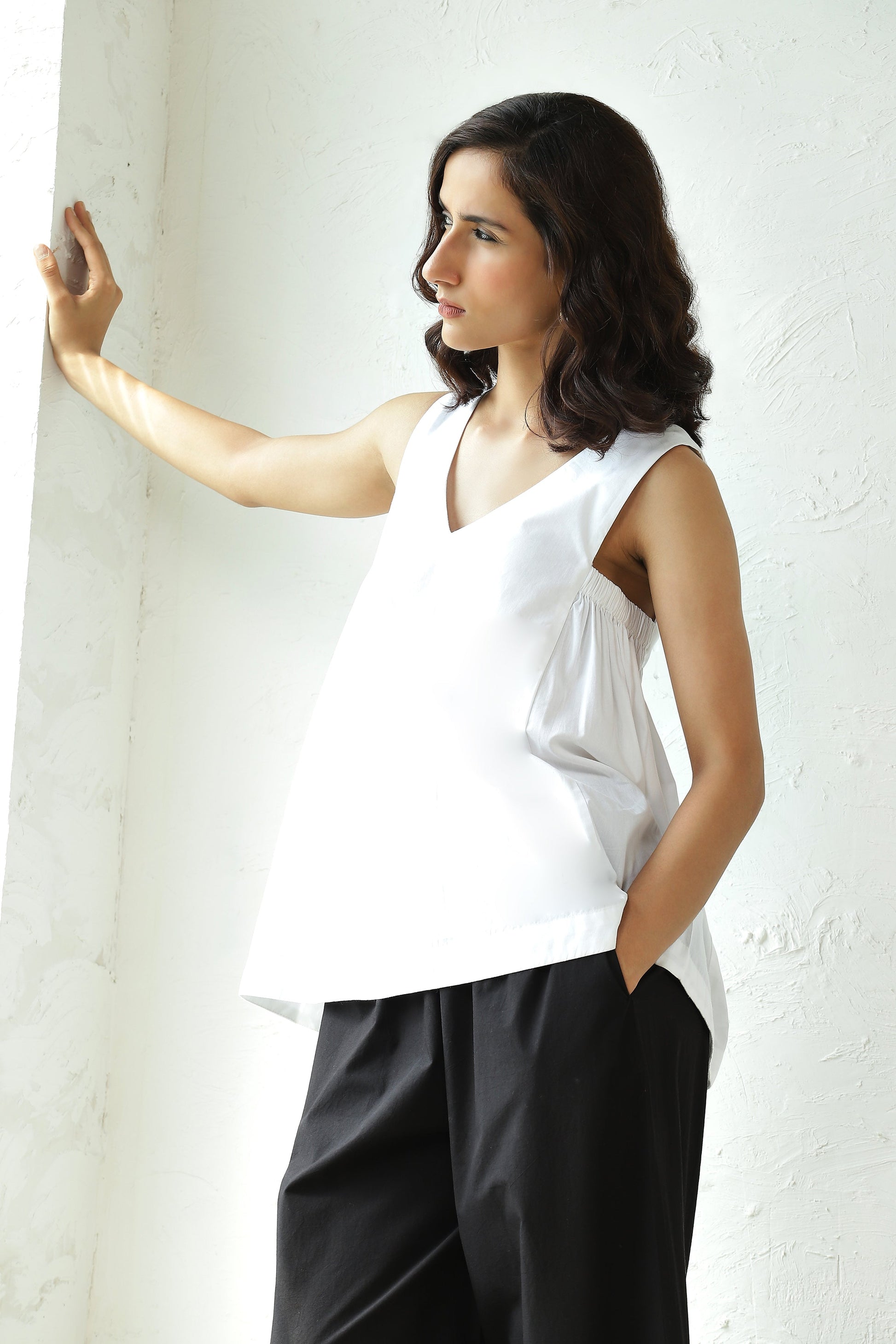 White Sleeveless V Neck Top With Black Flared Pant Set at Kamakhyaa by Canoopi. This item is Black, Canoopi, Casual Wear, Complete Sets, Natural, Poplin, Regular Fit, Solids, Vacation Co-ords, White, Womenswear