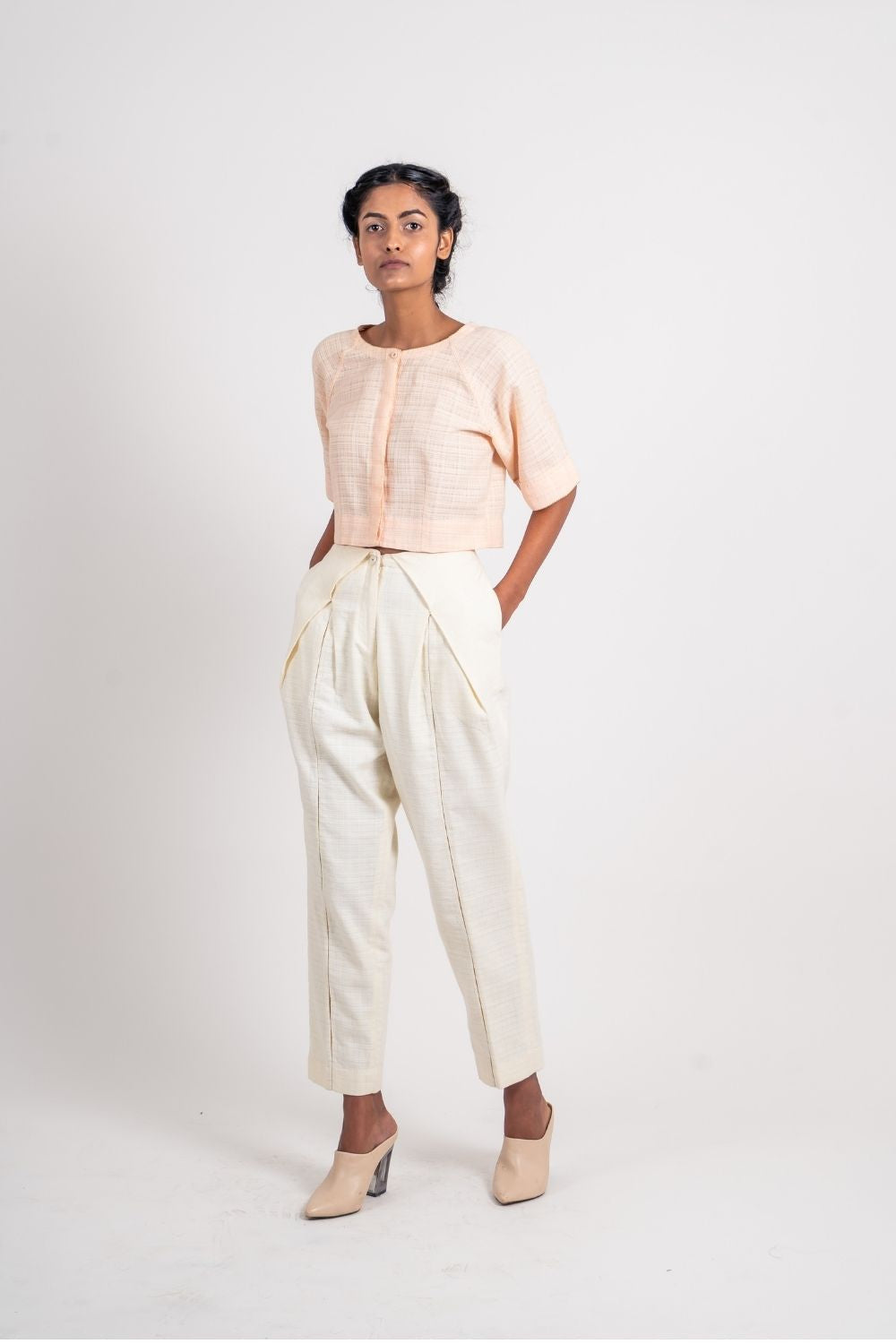 White Textured Pleated Pant at Kamakhyaa by Ahmev. This item is Casual Wear, Fitted At Waist, Handloom Cotton, Highend fashion, July Sale, July Sale 2023, Natural, Solids, Trousers, White, Womenswear
