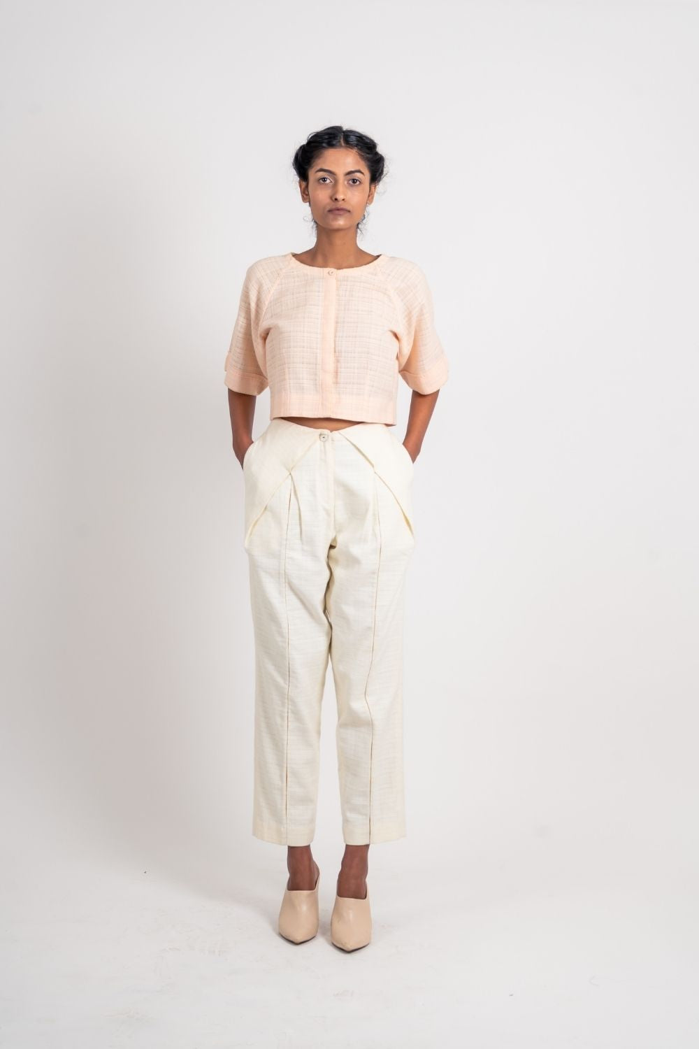 White Textured Pleated Pant at Kamakhyaa by Ahmev. This item is Casual Wear, Fitted At Waist, Handloom Cotton, Highend fashion, July Sale, July Sale 2023, Natural, Solids, Trousers, White, Womenswear