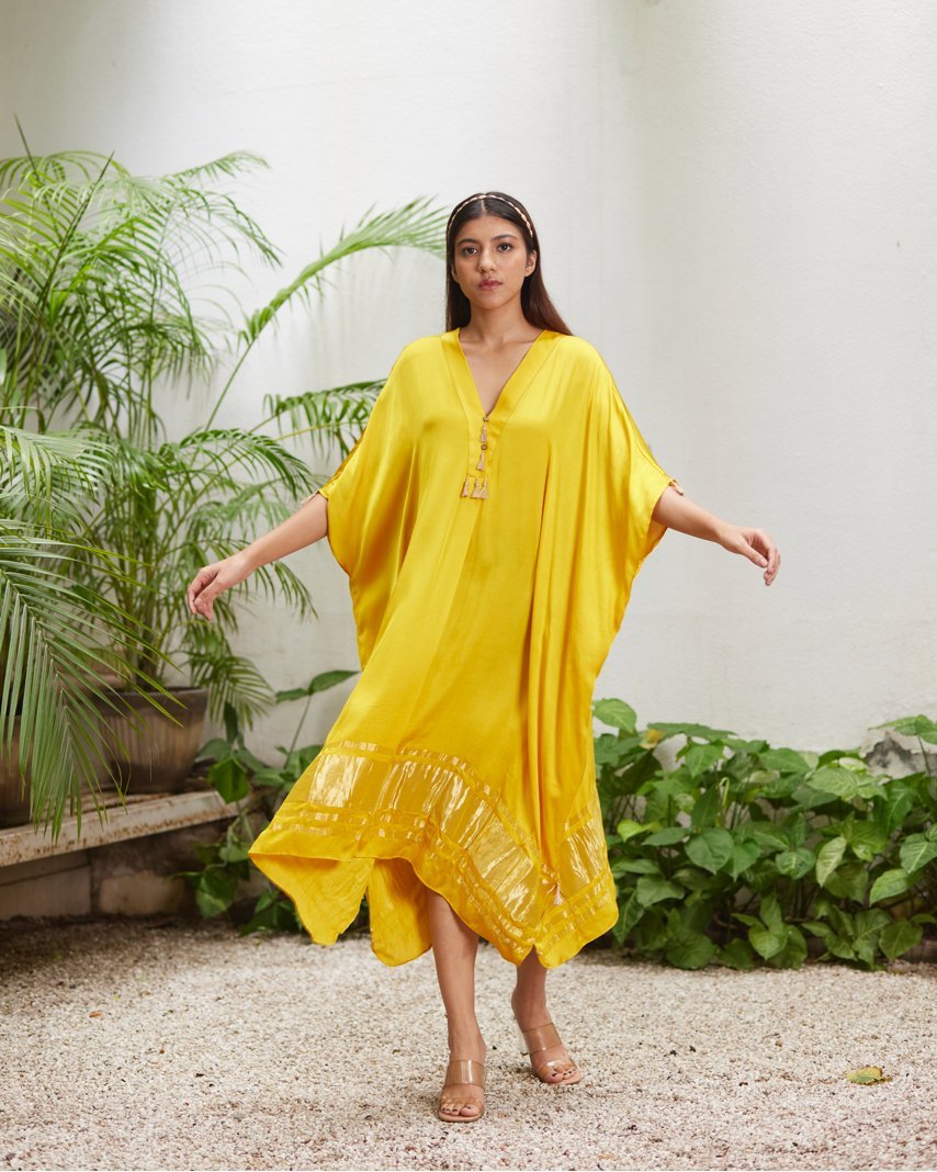 Yellow Silk Kaftan With Golden Border at Kamakhyaa by Mayura Kumar. This item is Ajrakh Heritage, Casual Wear, Dresses, Festive Wear, Kaftans, Mayura Kumar, Modal Silk, Relaxed Fit, Solids, Womenswear, Yellow