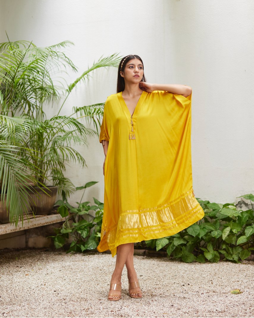 Yellow Silk Kaftan With Golden Border at Kamakhyaa by Mayura Kumar. This item is Ajrakh Heritage, Casual Wear, Dresses, Festive Wear, Kaftans, Mayura Kumar, Modal Silk, Relaxed Fit, Solids, Womenswear, Yellow