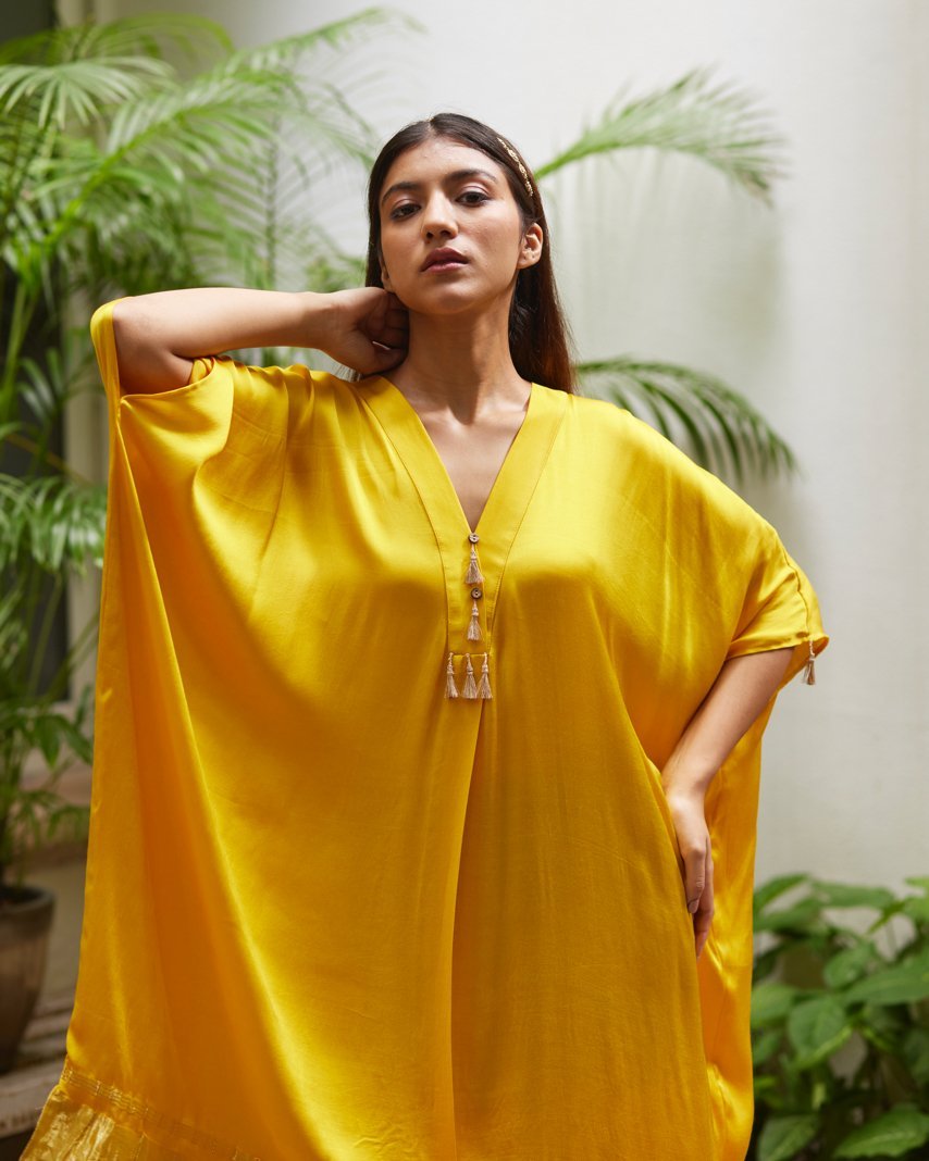 Yellow Silk Kaftan With Golden Border at Kamakhyaa by Mayura Kumar. This item is Ajrakh Heritage, Casual Wear, Dresses, Festive Wear, Kaftans, Mayura Kumar, Modal Silk, Relaxed Fit, Solids, Womenswear, Yellow