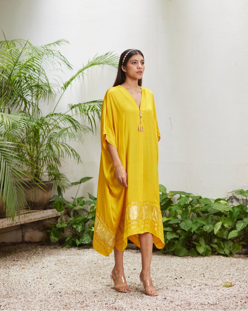 Yellow Silk Kaftan With Golden Border at Kamakhyaa by Mayura Kumar. This item is Ajrakh Heritage, Casual Wear, Dresses, Festive Wear, Kaftans, Mayura Kumar, Modal Silk, Relaxed Fit, Solids, Womenswear, Yellow